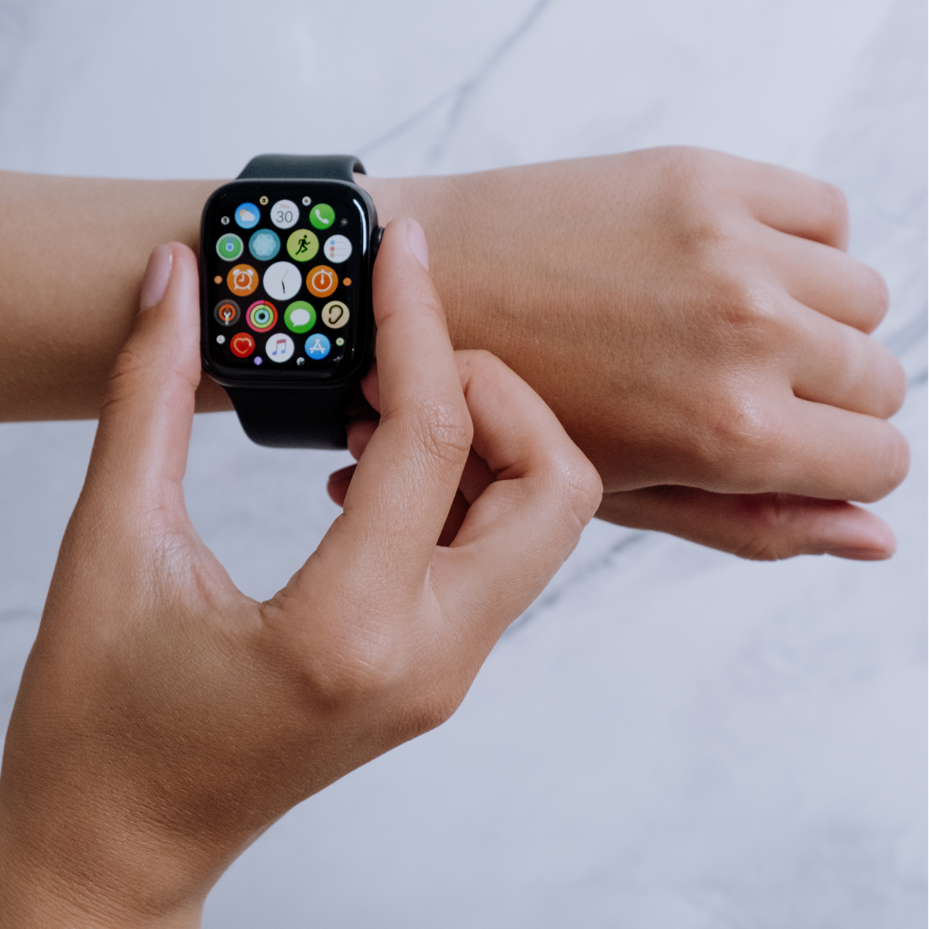 women with apple watch on wrist looking at screen