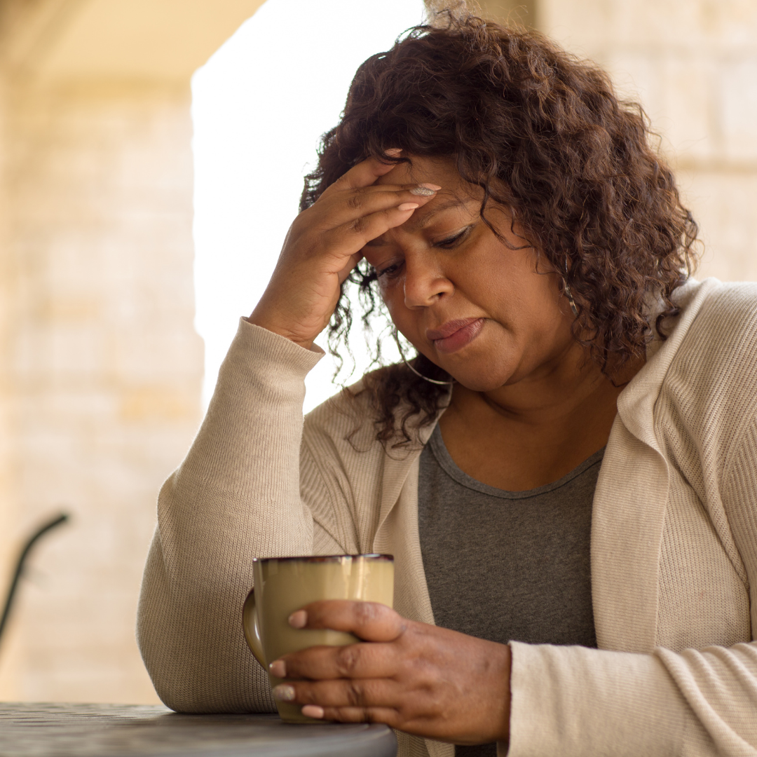 women looking stressed at coffee cup
